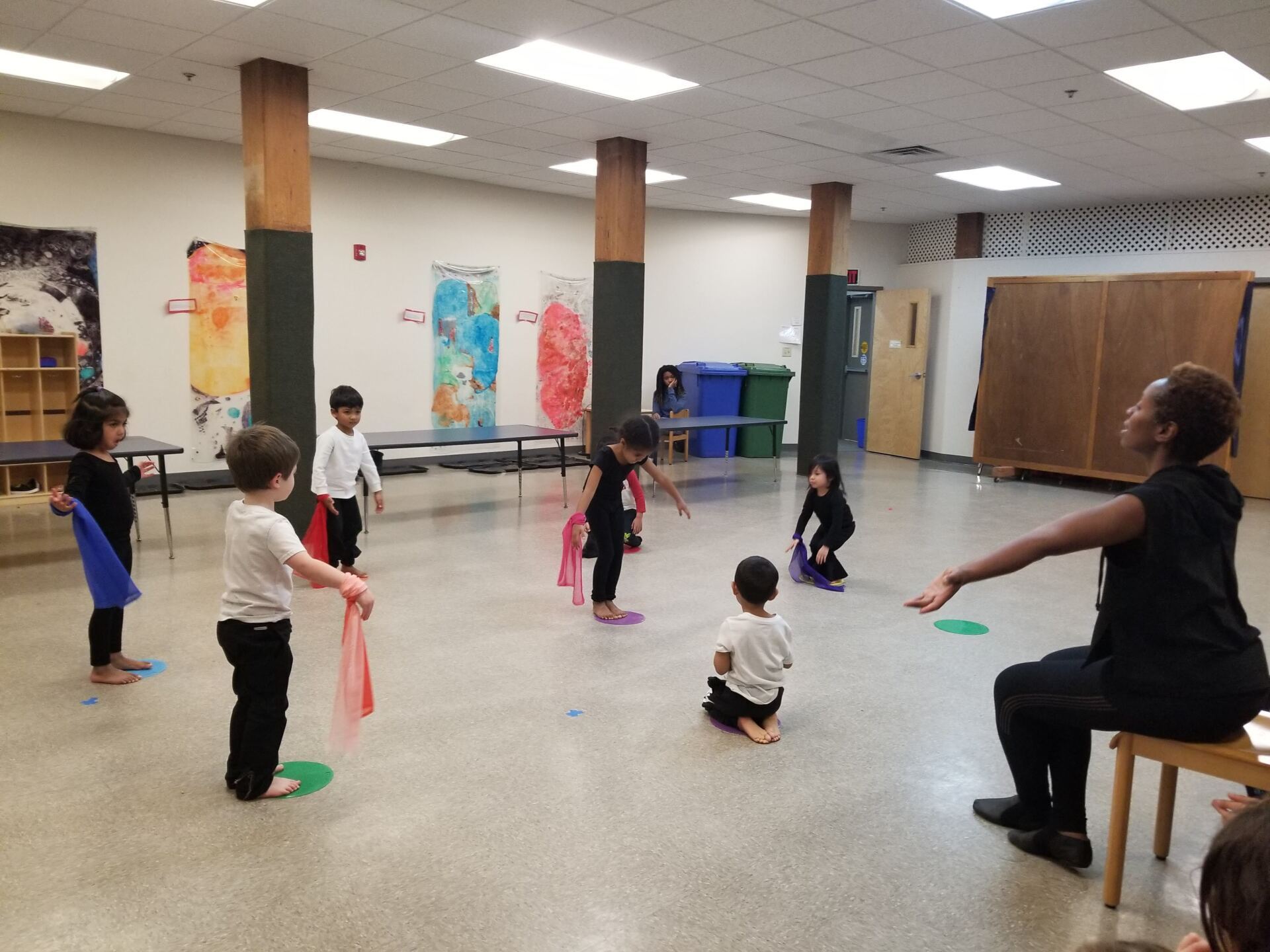 A group of children and guide working in a Montessori classroom