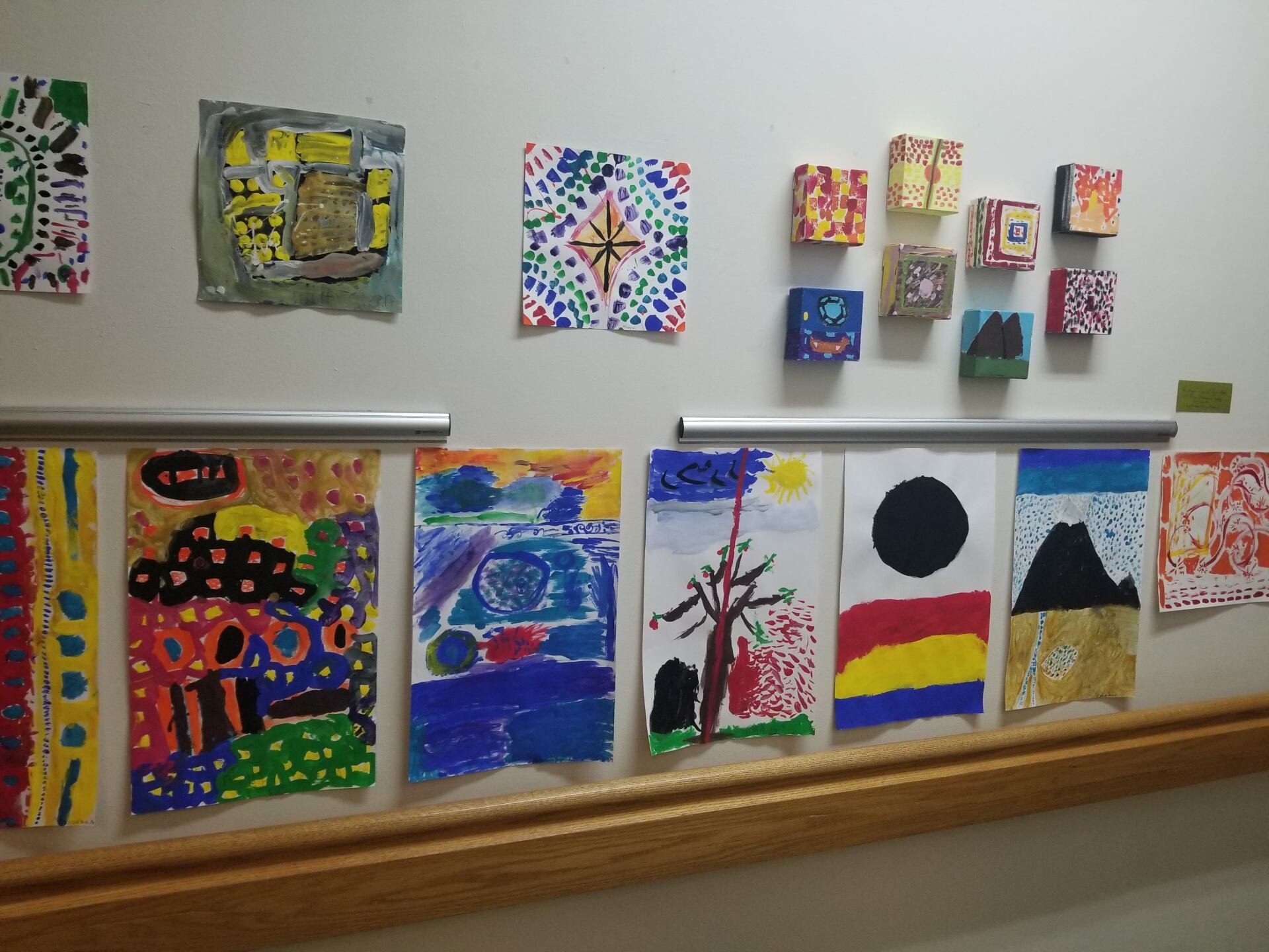 Montessori classroom wall with a bunch of paintings on it