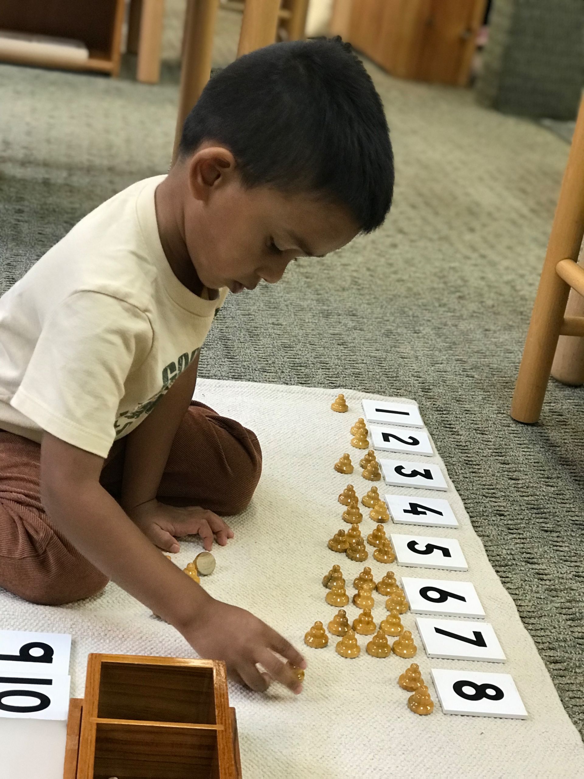 Montessori child working with math materials