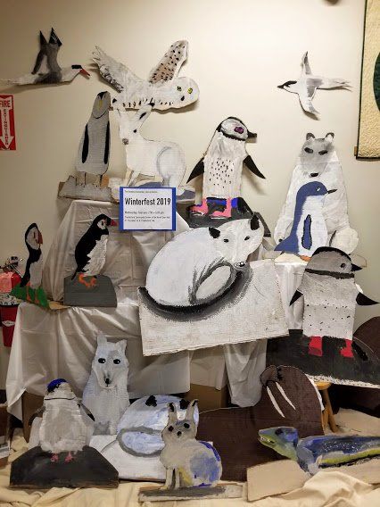 A display of paper animals with a sign that says winterfest 2011