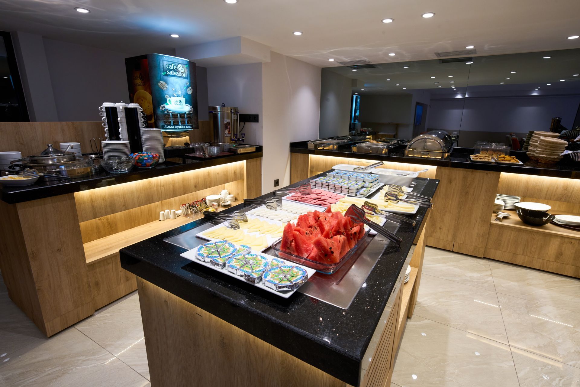 A buffet table with watermelon on it in a restaurant.