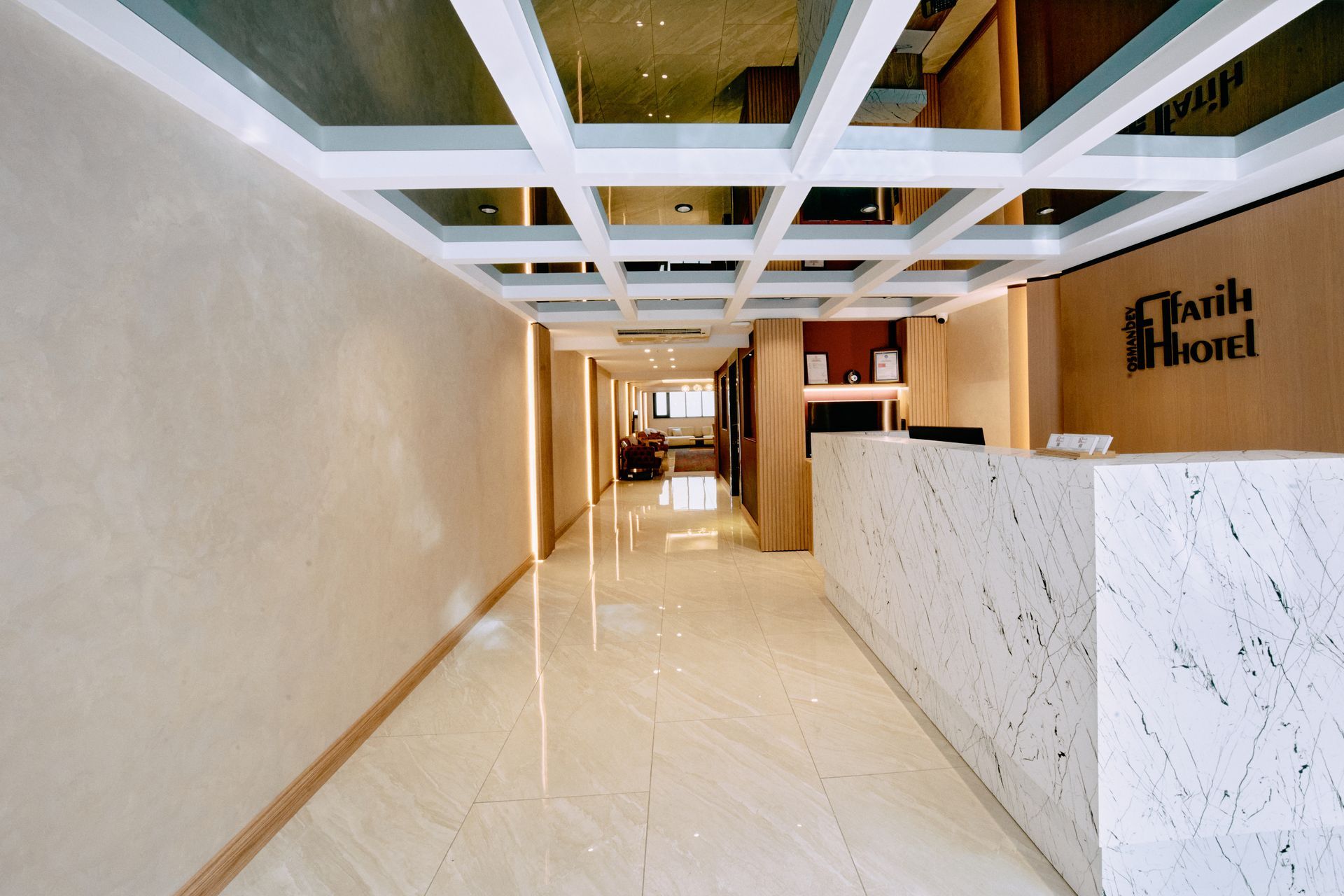 A hotel lobby with a white counter and a sign that says faith hotel