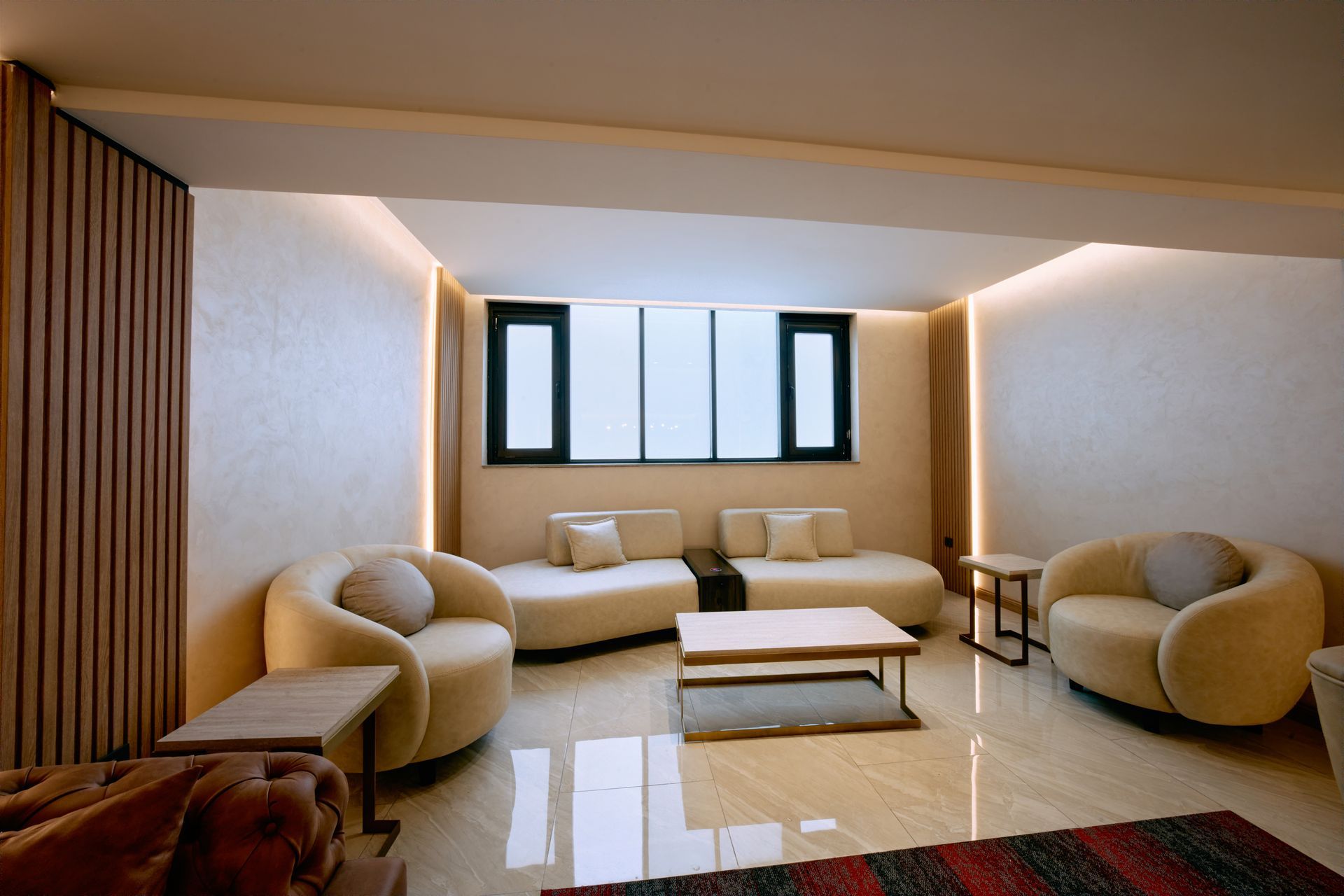 A living room with a couch , chairs and a coffee table