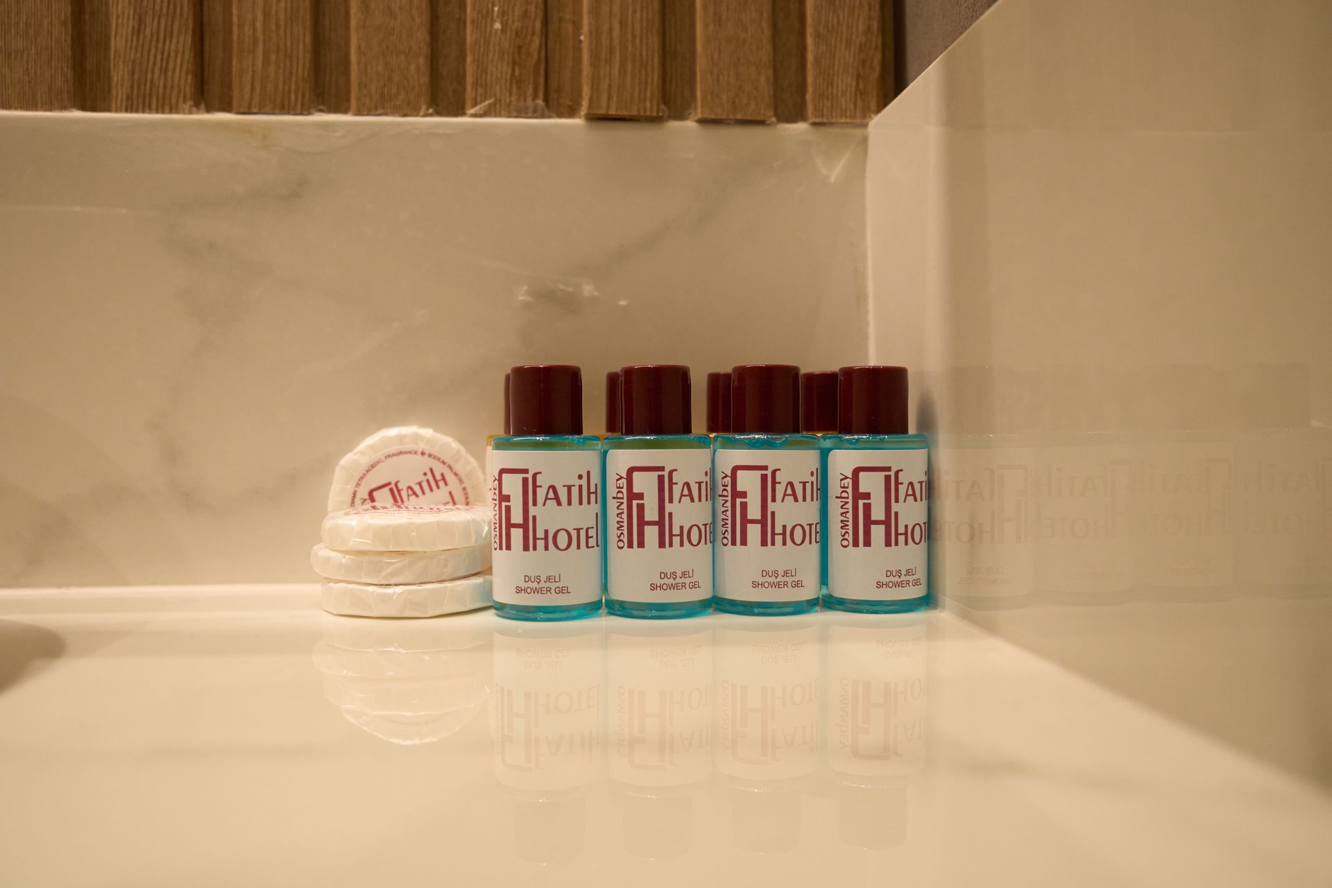 A bathroom counter with bottles of shampoo and soap on it.