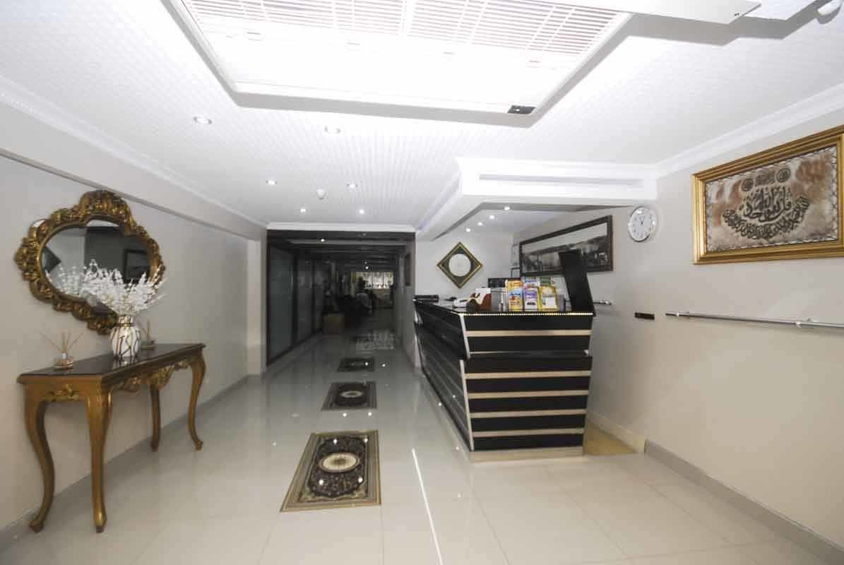 A hotel lobby with a desk and a mirror