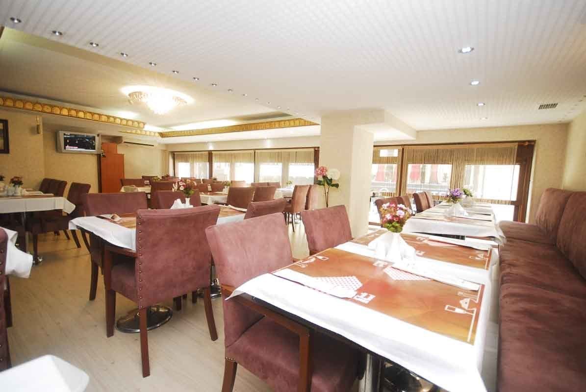 A restaurant with tables and chairs and a couch