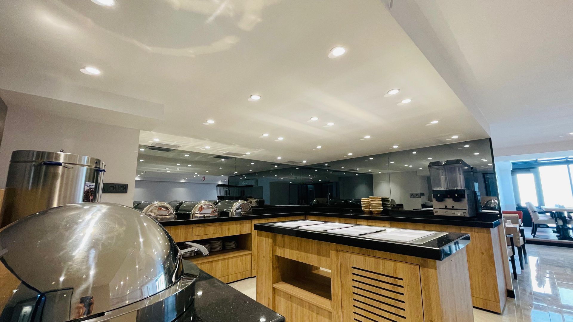 A large kitchen with a lot of appliances and a buffet table.