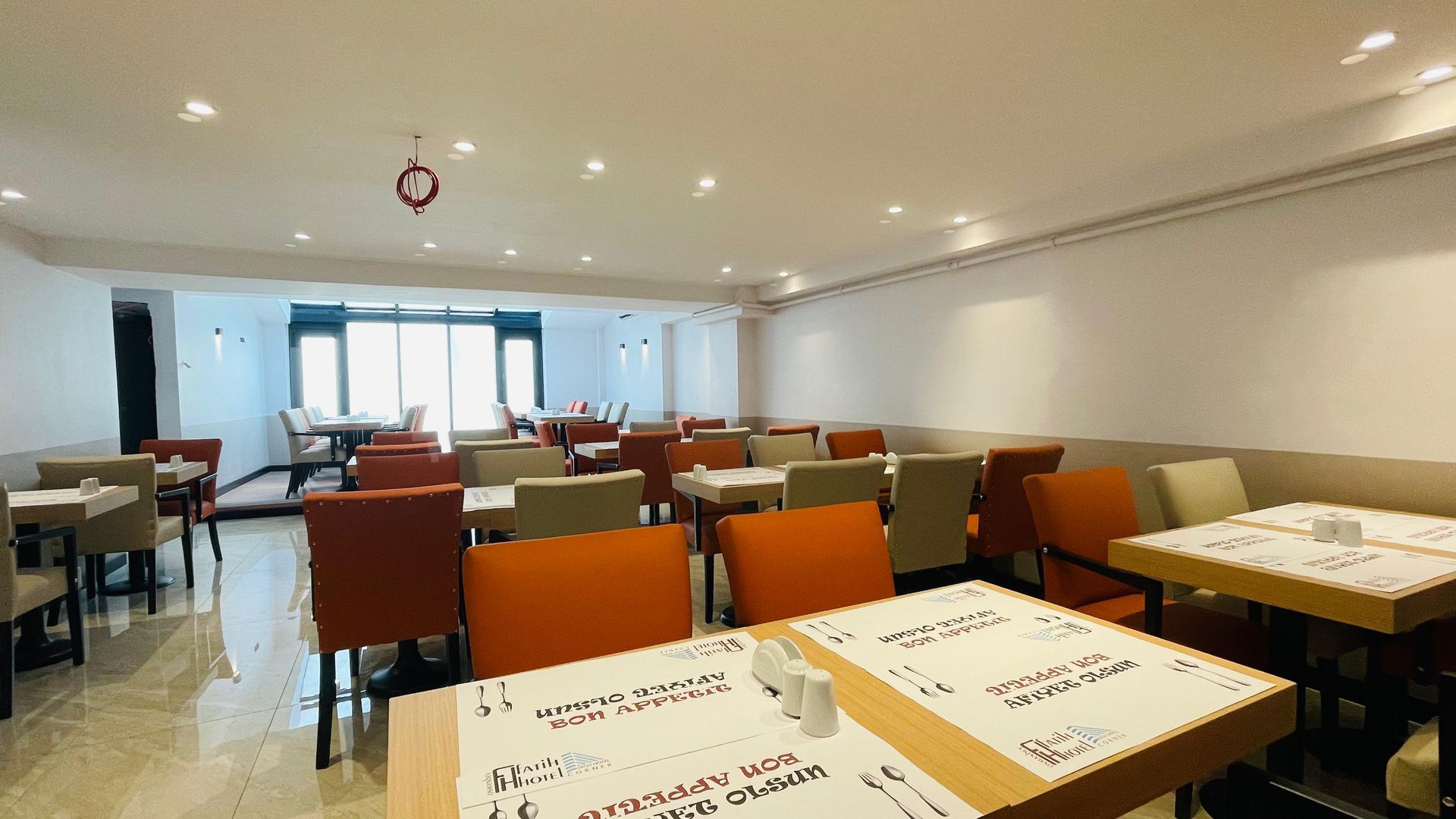 There are many tables and chairs in the restaurant.