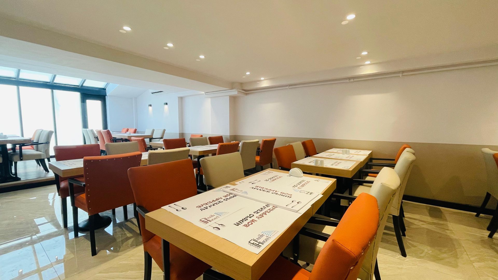 There are many tables and chairs in the restaurant.