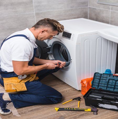 Man Repairing Dishwasher — Canberra, ACT — Renewed Appliances - Manhos
