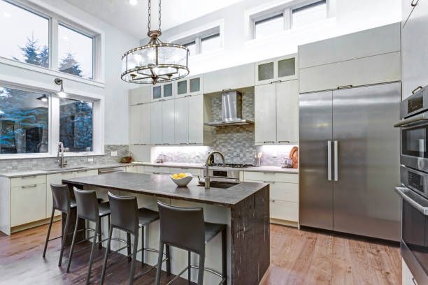 Elegant white kitchen featuring premium appliances, perfect for luxury house designs inspiration.