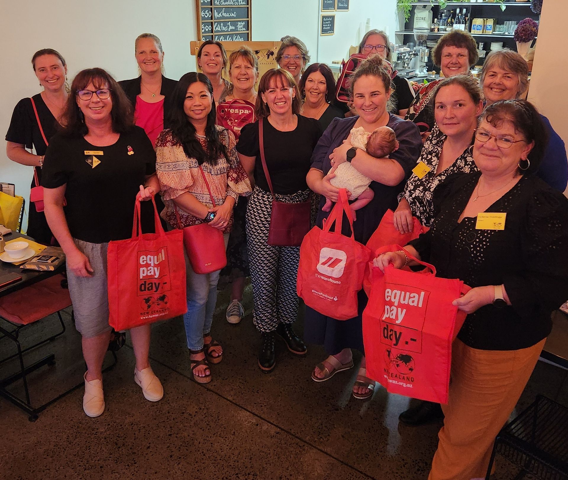 a woman is sitting at a desk with a laptop and writing in a notebook .