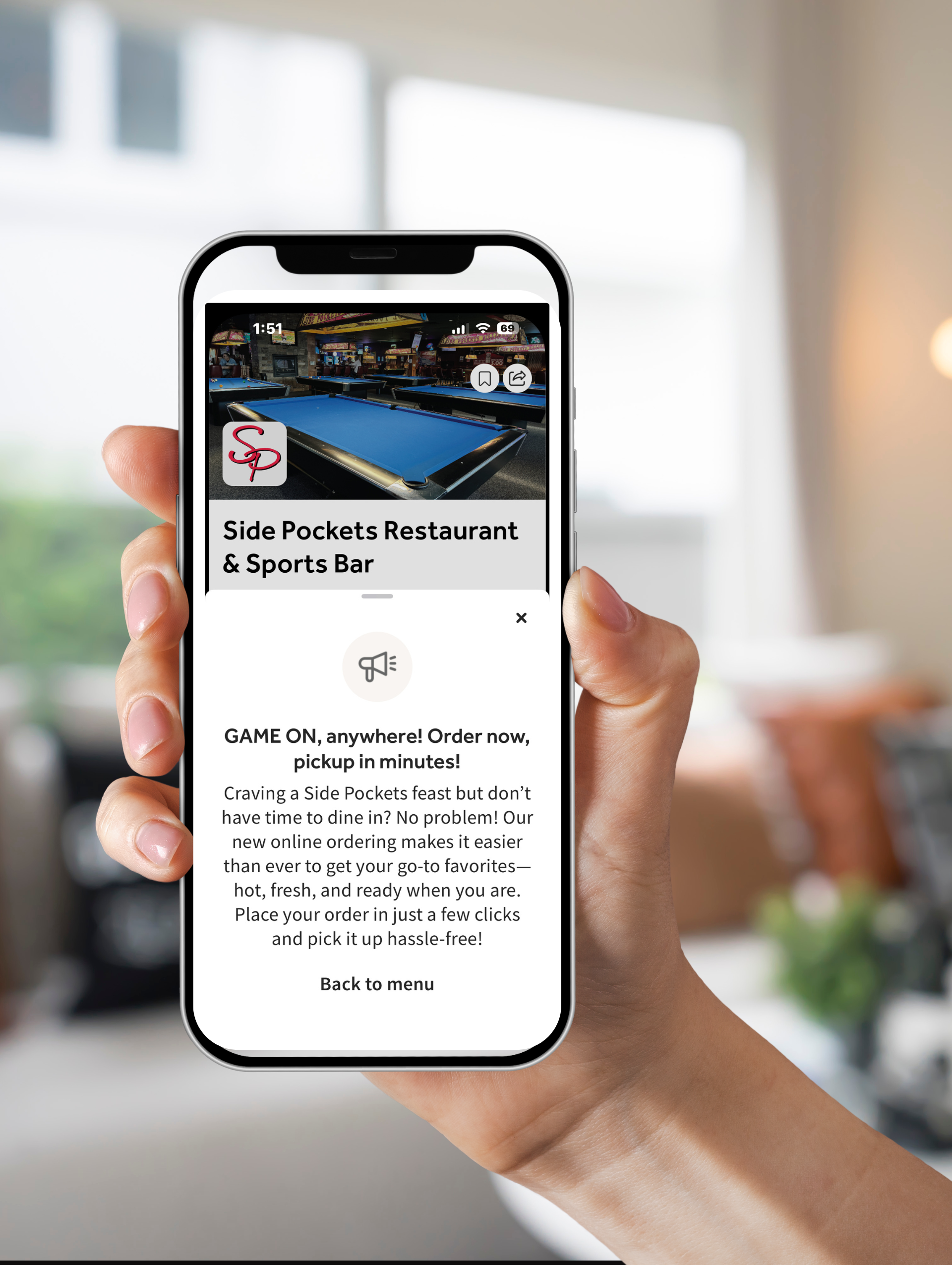 A person is holding a cell phone in their hand.