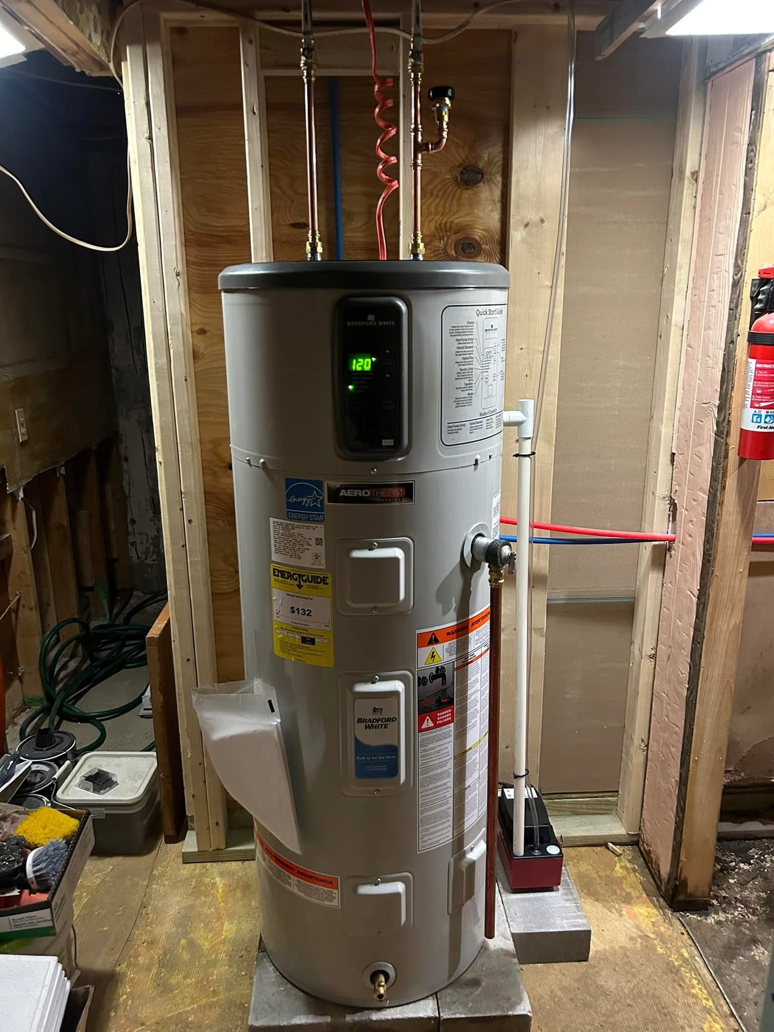A water heater is sitting in a basement next to a wall.