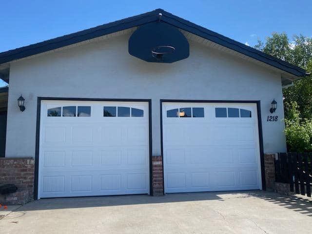 A white garage door with a basketball hoop on top of it