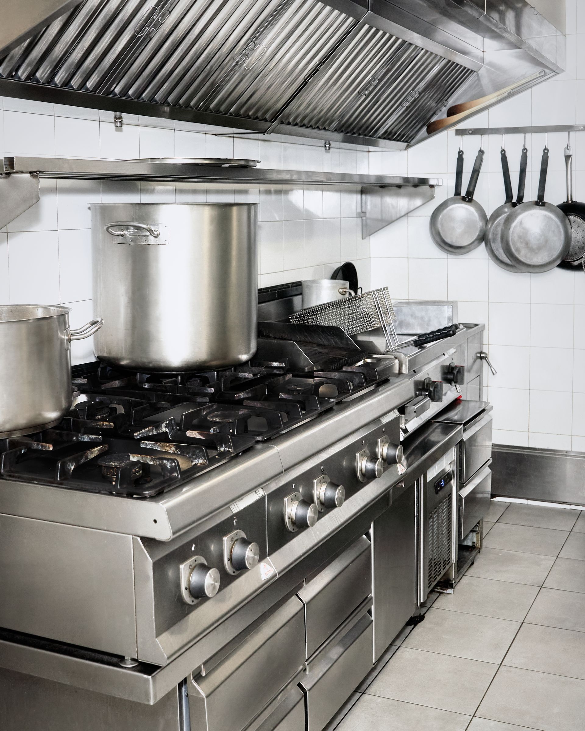 A kitchen with pots and pans on the stove