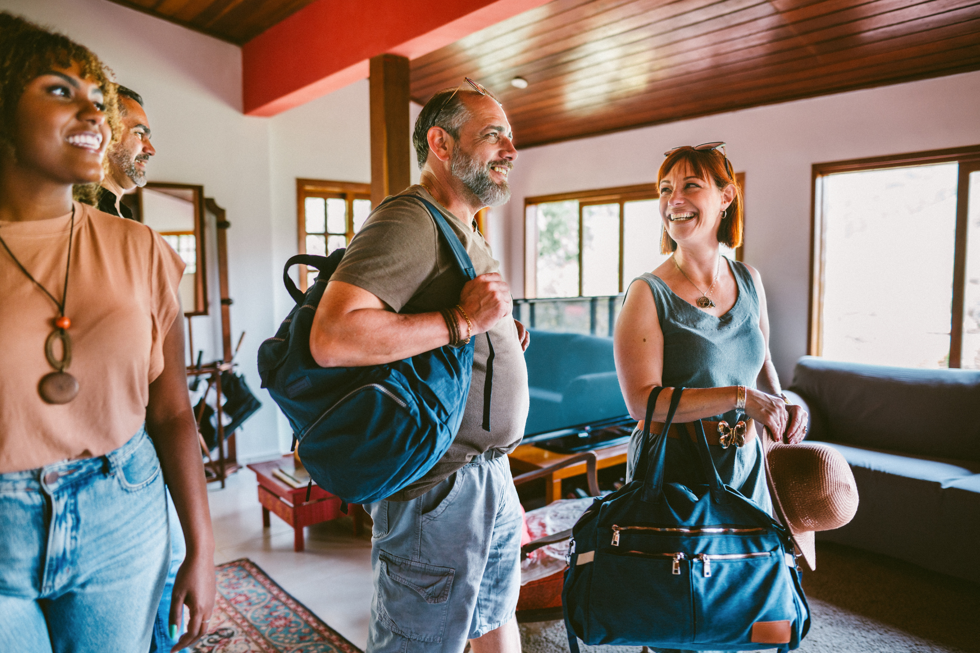 Wooden cabins on a hillside, with steps leading up to the entrance and surrounding greenery.