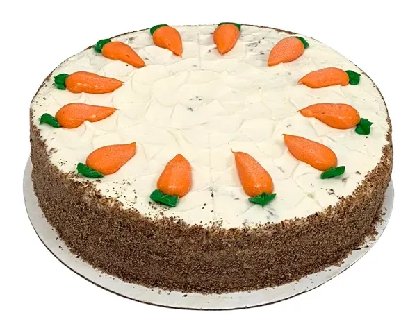 Pastel de zanahoria con glaseado blanco y decoraciones de zanahoria naranja en un plato blanco de Azúcar y Cacao
