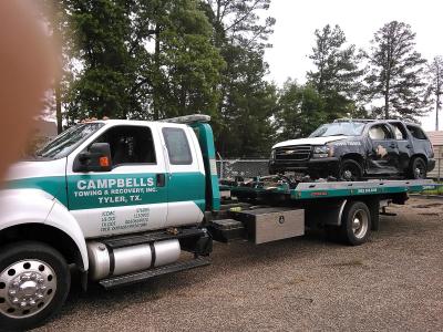Flatbed truck hauling an SUV