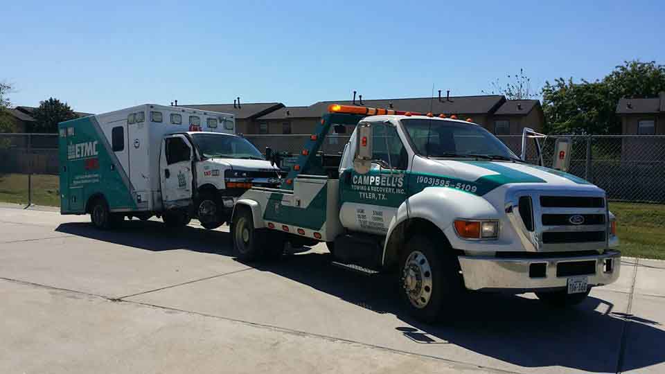 Tow truck hauling an ambulance