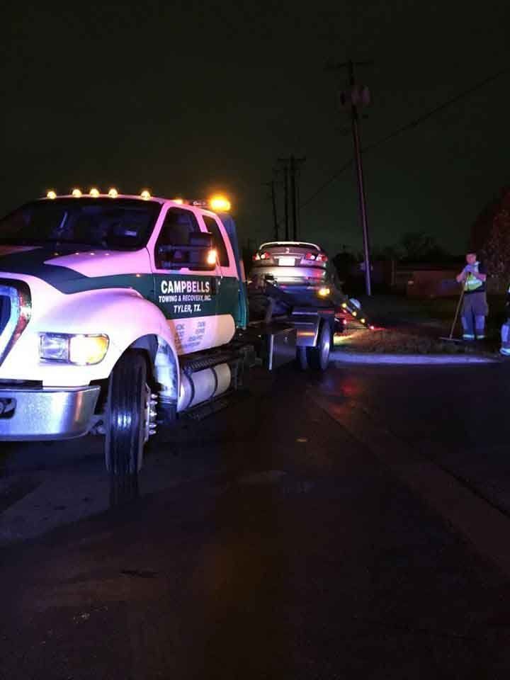 Tow truck at nighttime accident scene
