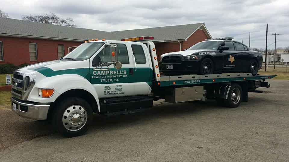 Texas state trooper car on tow truck