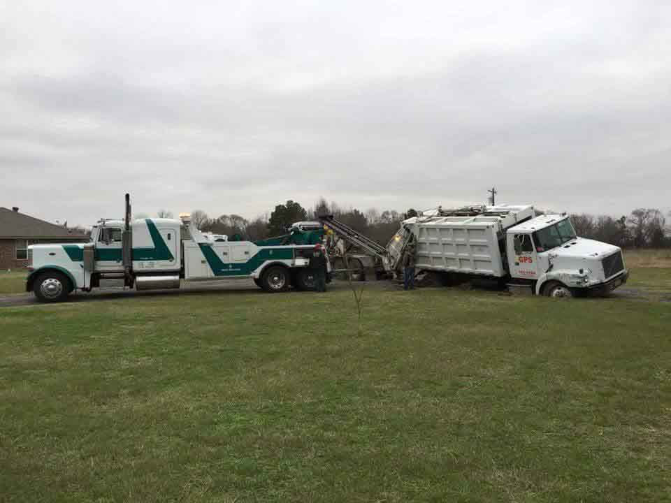 Garbage truck being towed