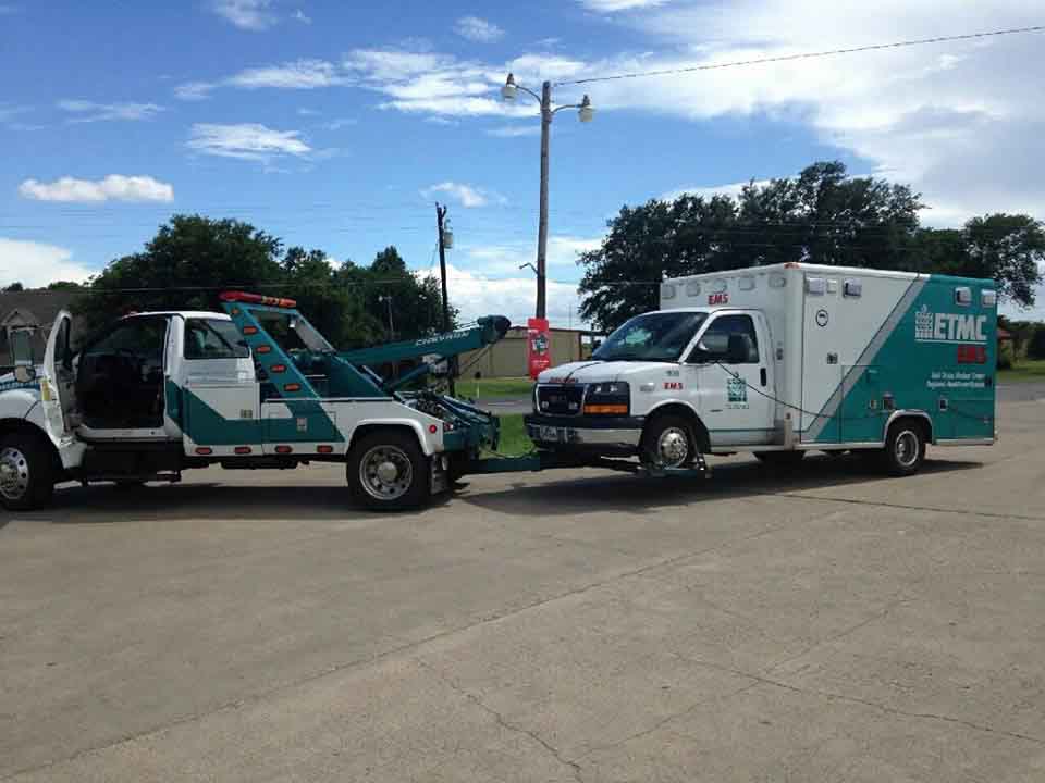 Tow truck hauling an ambulance