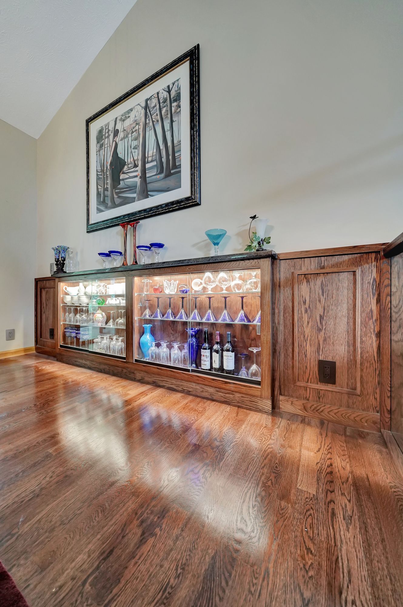 There is a picture on the wall above the display case.