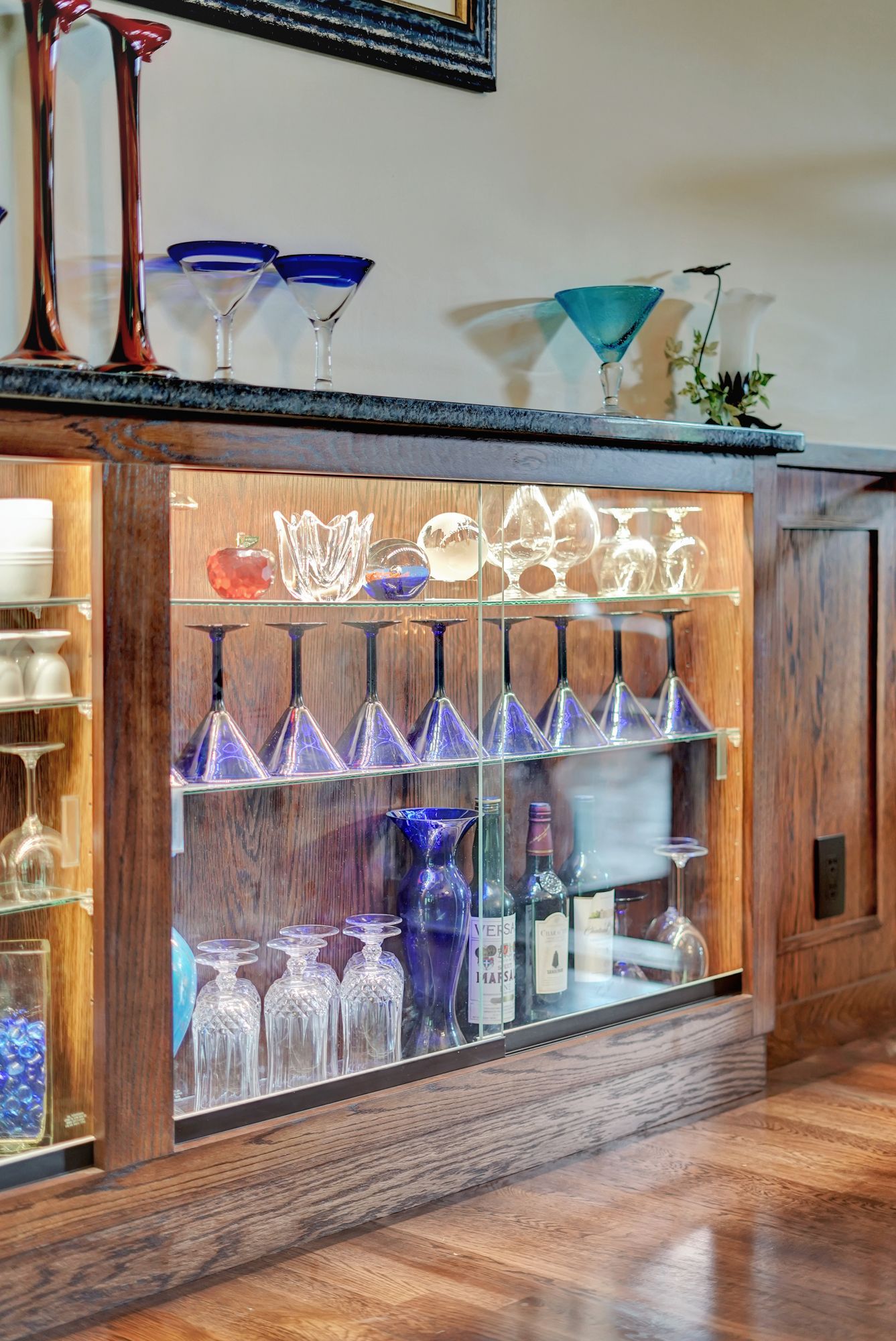 A glass cabinet filled with wine glasses and bottles