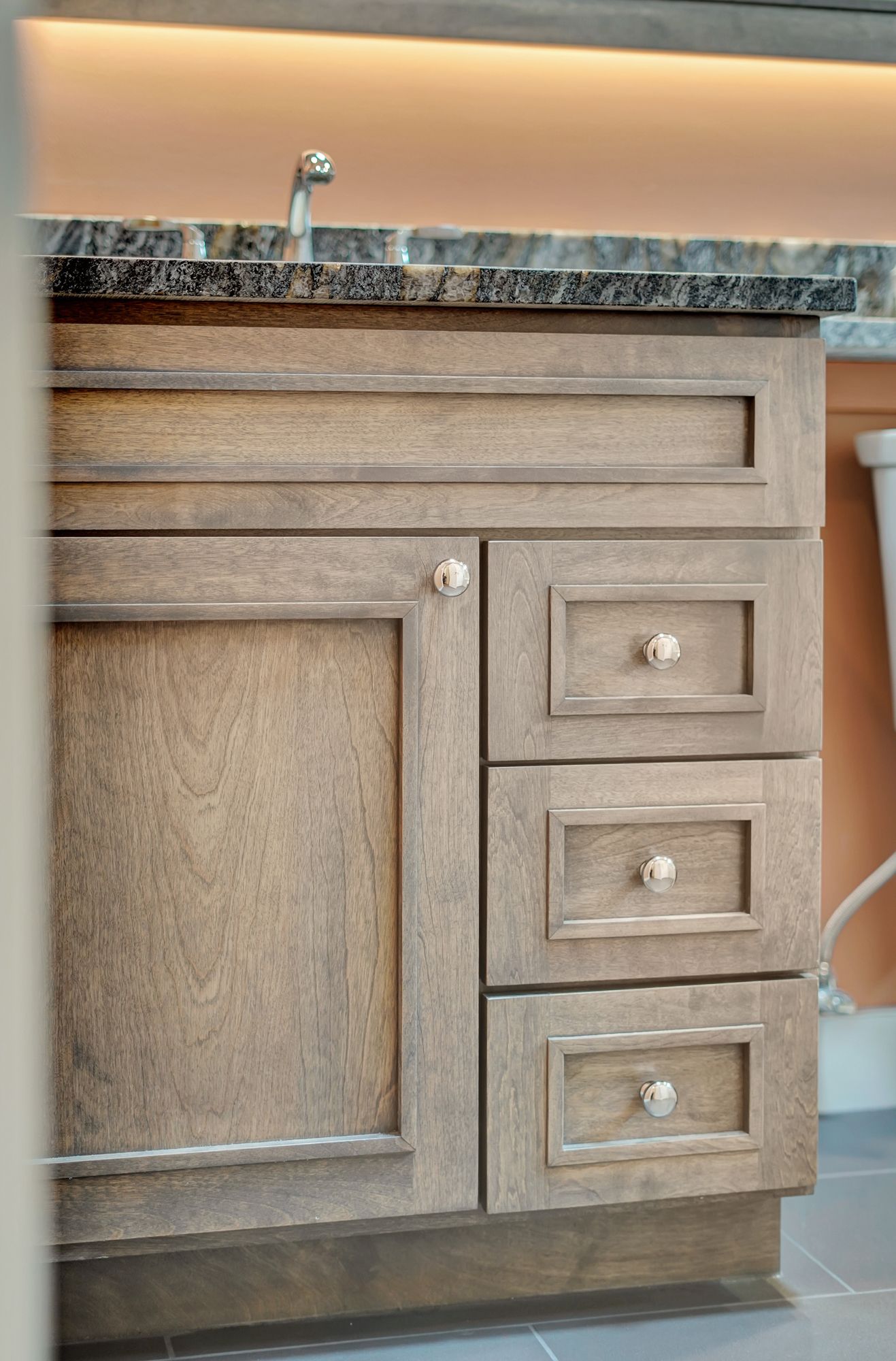 A bathroom vanity with drawers and a sink.