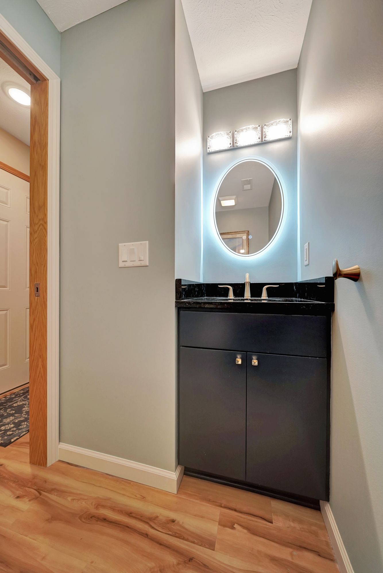 A bathroom with a sink and a mirror on the wall.
