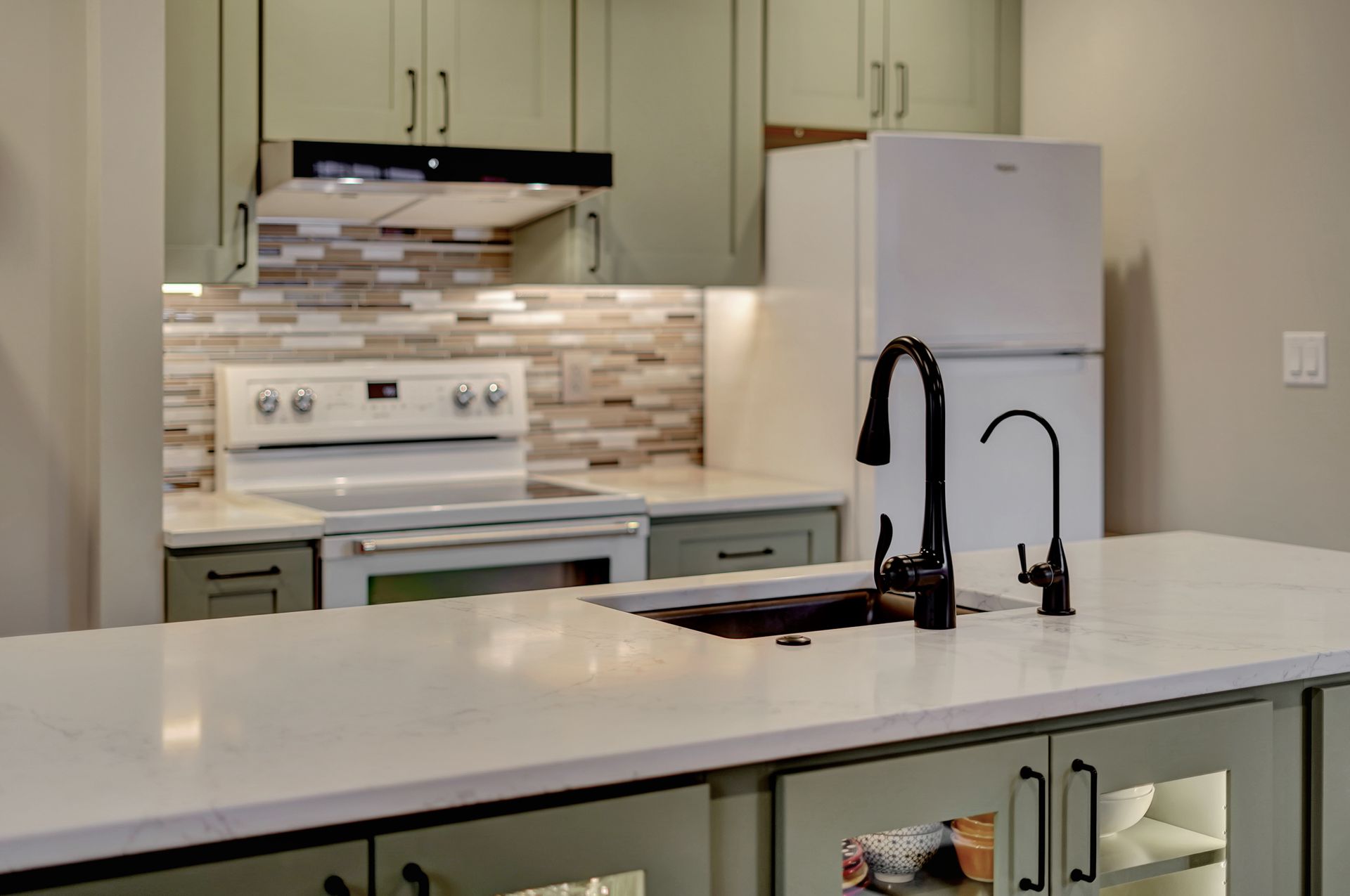 A kitchen with a sink , stove , refrigerator , and cabinets | Lincoln, NE | SkyLimit Remodeling