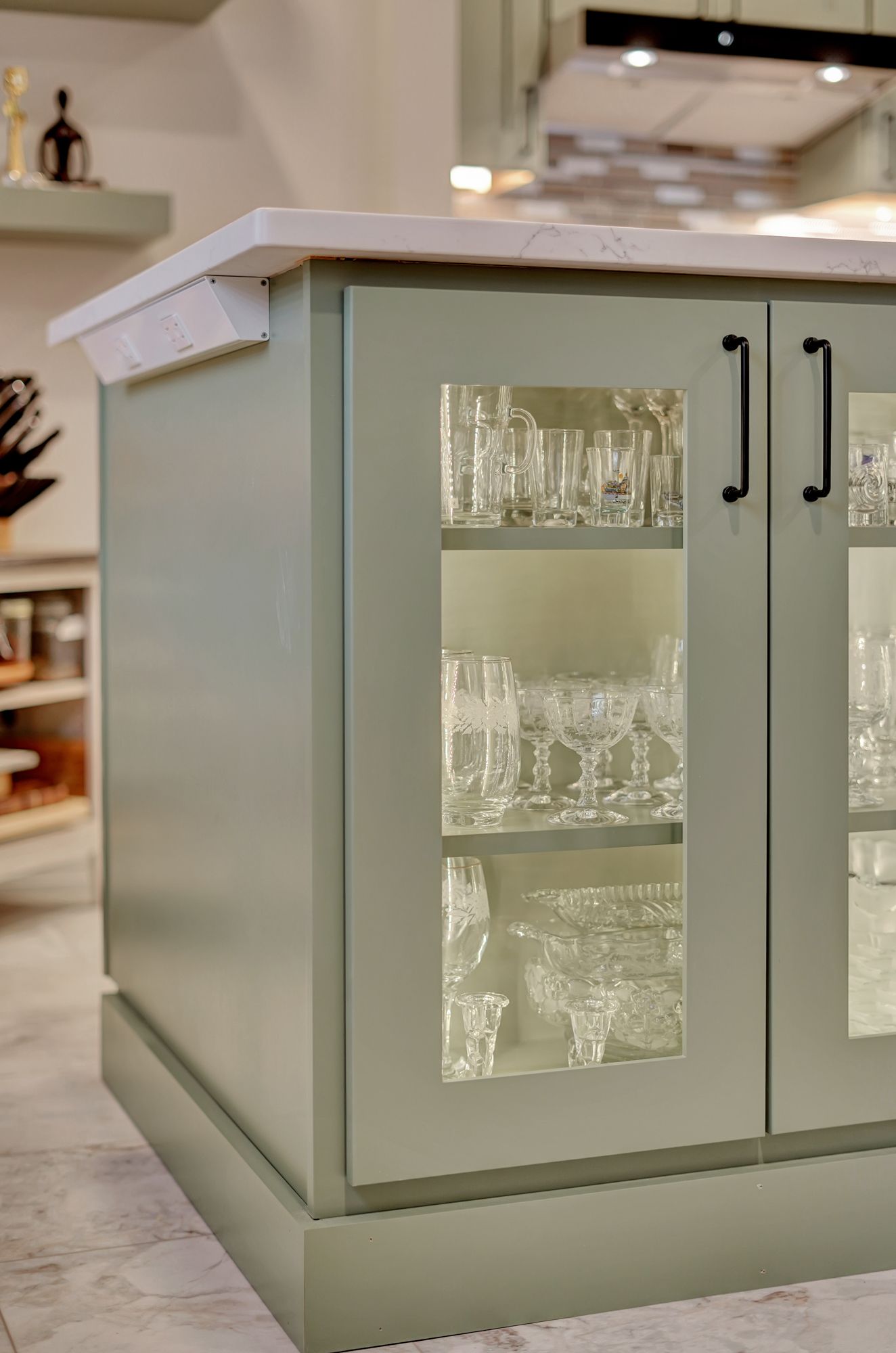 A kitchen island with a glass door filled with wine glasses | Lincoln, NE | SkyLimit Remodeling