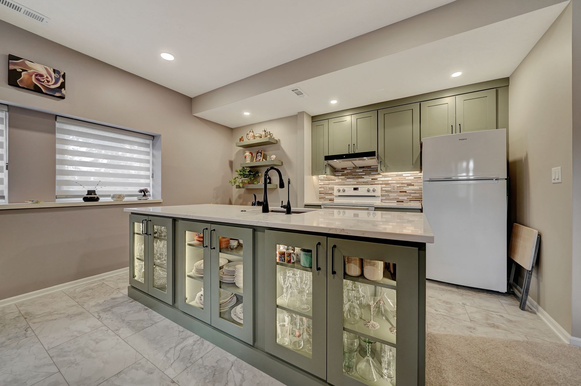 A kitchen with a large island in the middle and a refrigerator | Lincoln, NE | SkyLimit Remodeling