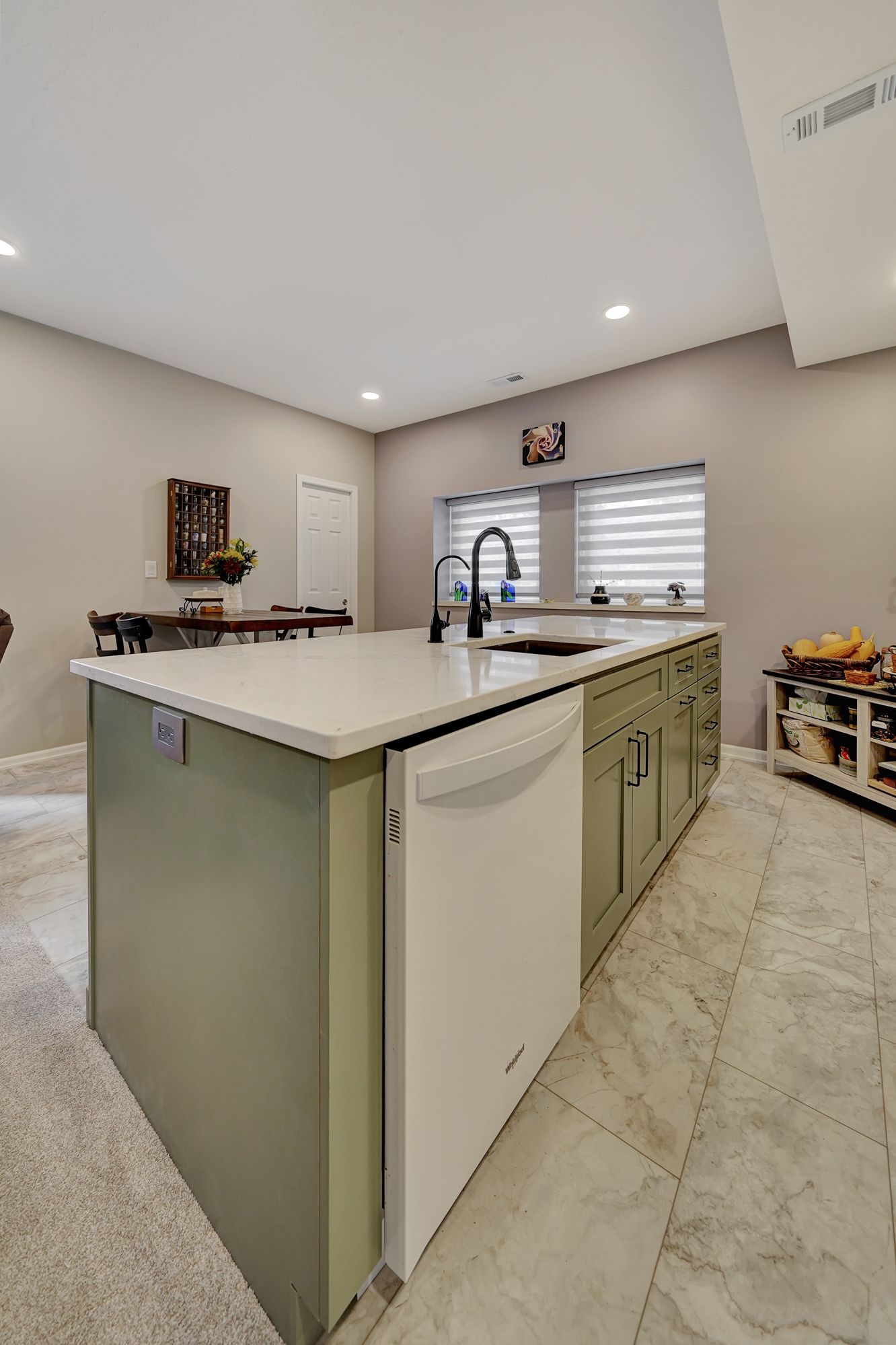 A kitchen with a large island and a white dishwasher | Lincoln, NE | SkyLimit Remodeling