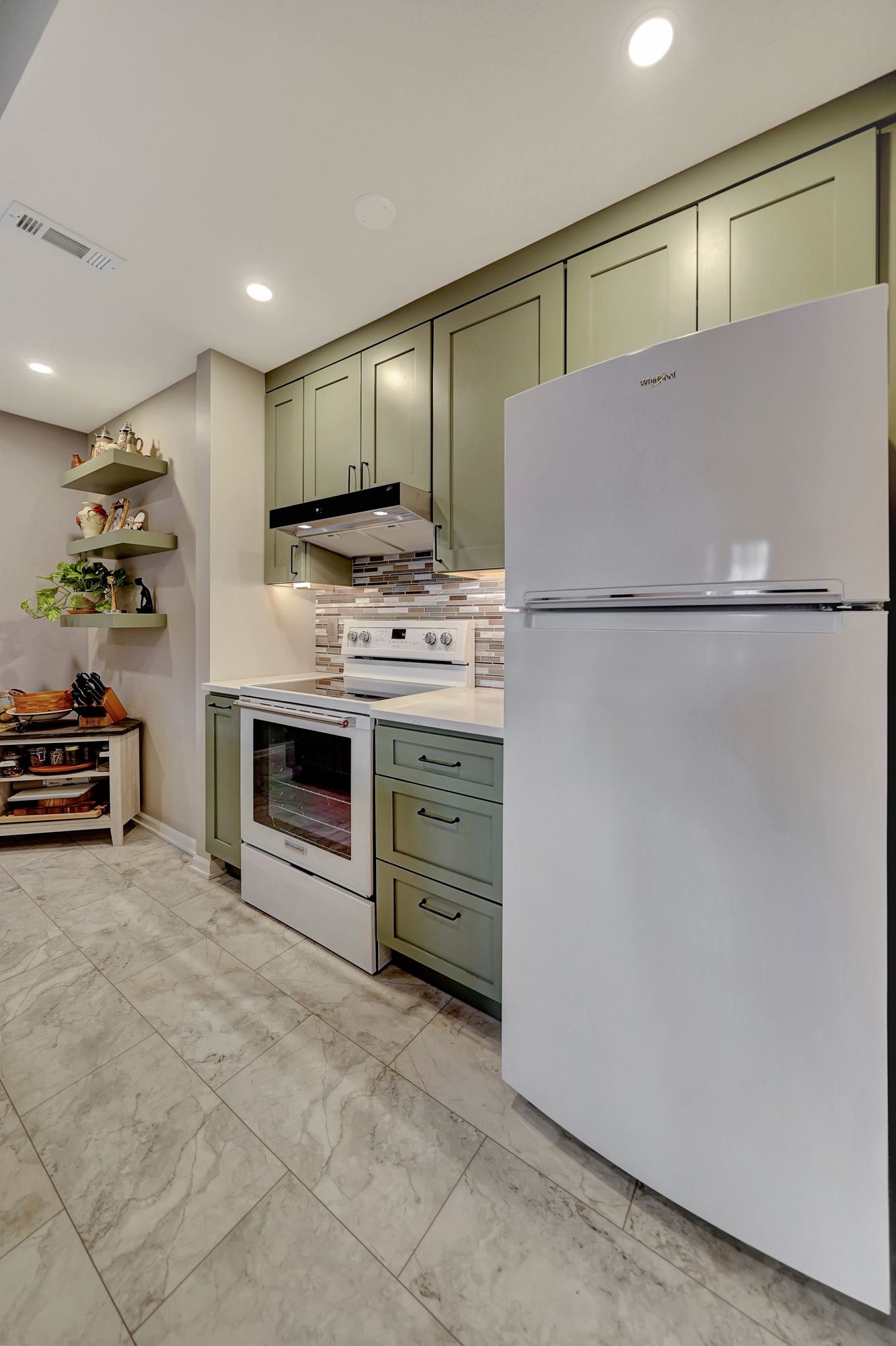 A kitchen with a white refrigerator , stove , and oven | Lincoln, NE | SkyLimit Remodeling
