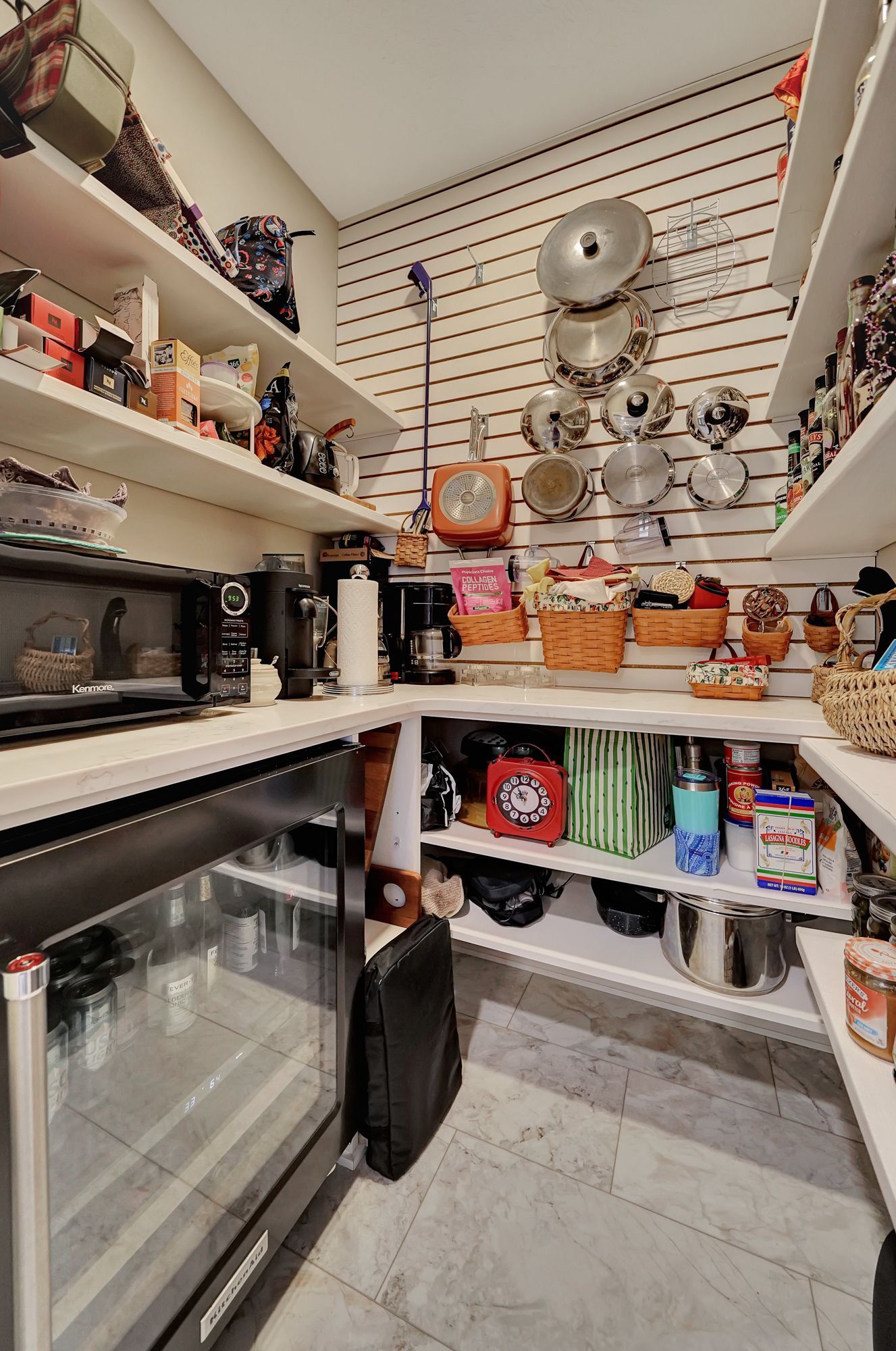 A pantry with lots of shelves and pots and pans on the wall | Lincoln, NE | SkyLimit Remodeling