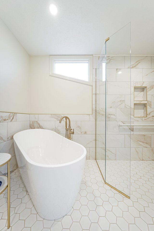 A white, free-standing tub and shower