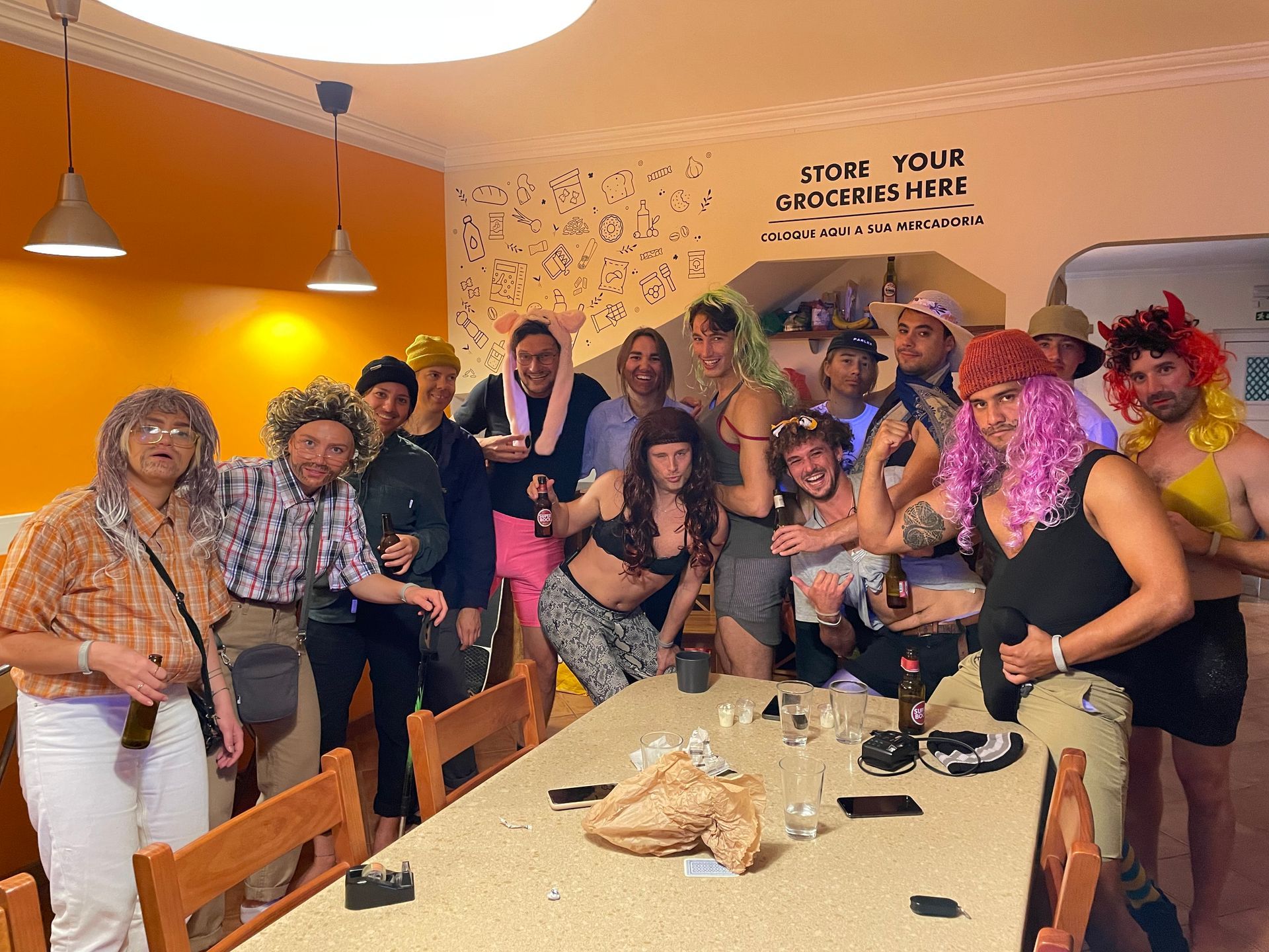 A group of people are posing for a picture in front of a long table.