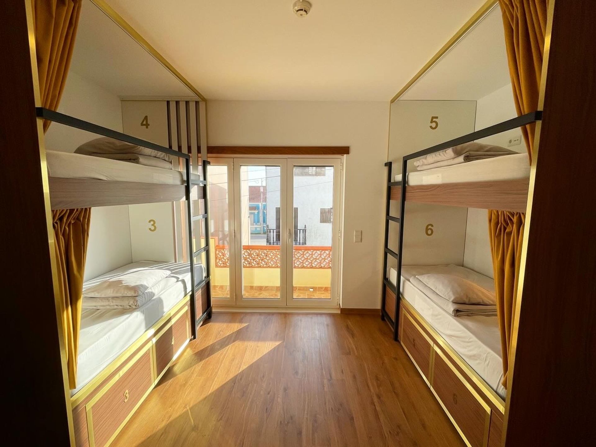 A room with bunk beds and a sliding glass door