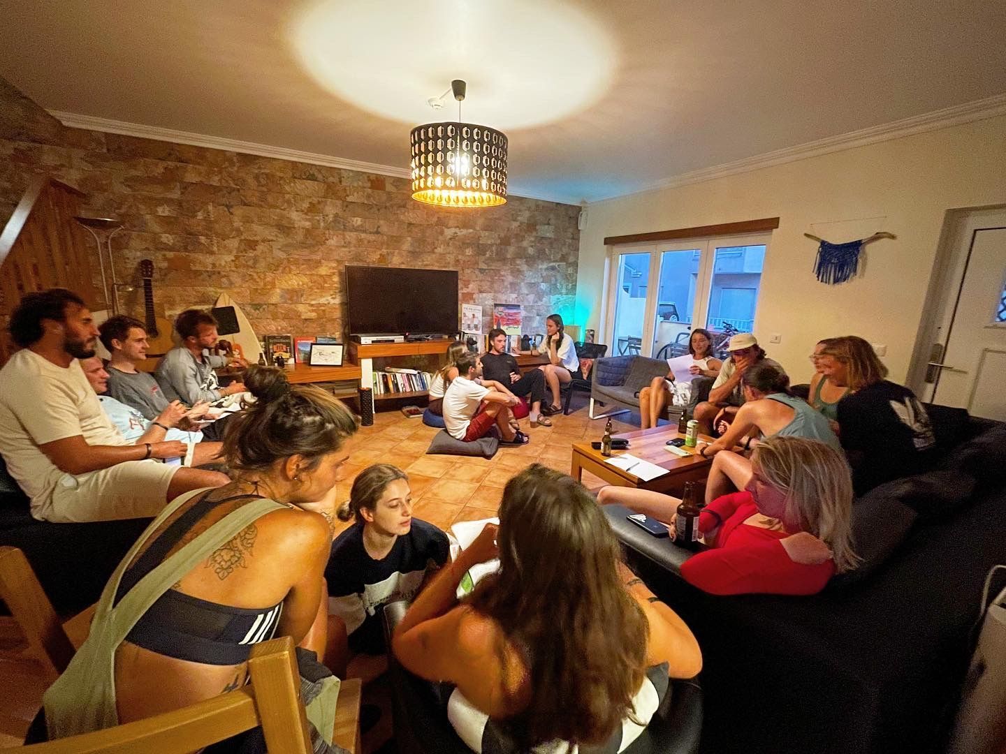 A group of people are sitting in a circle in a living room.