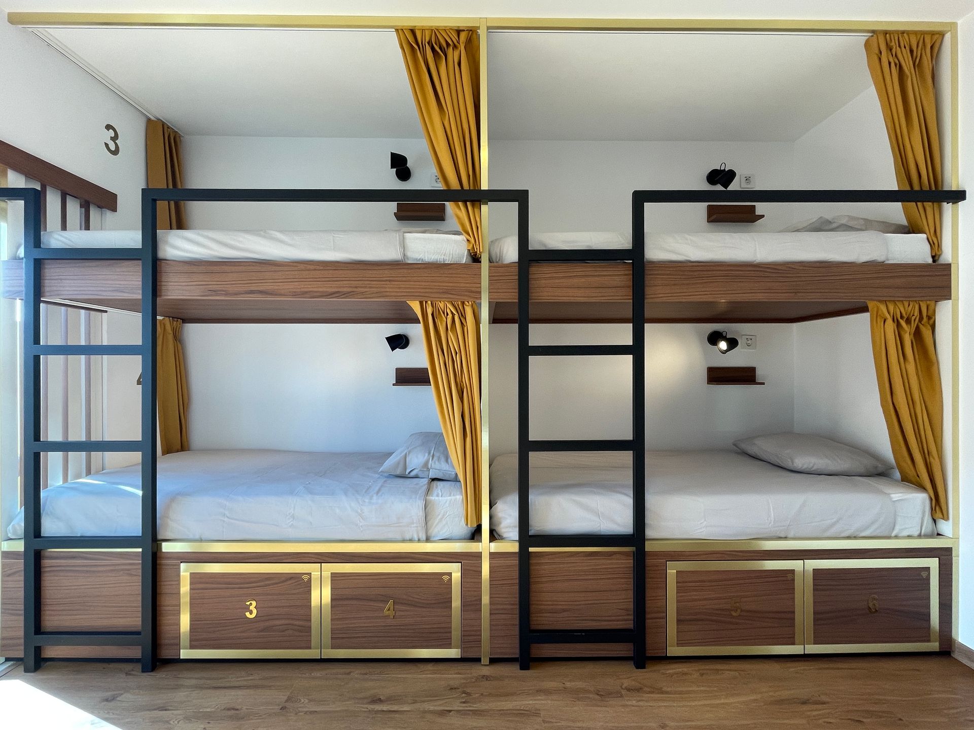 A bunk bed with the number 3 on the wall