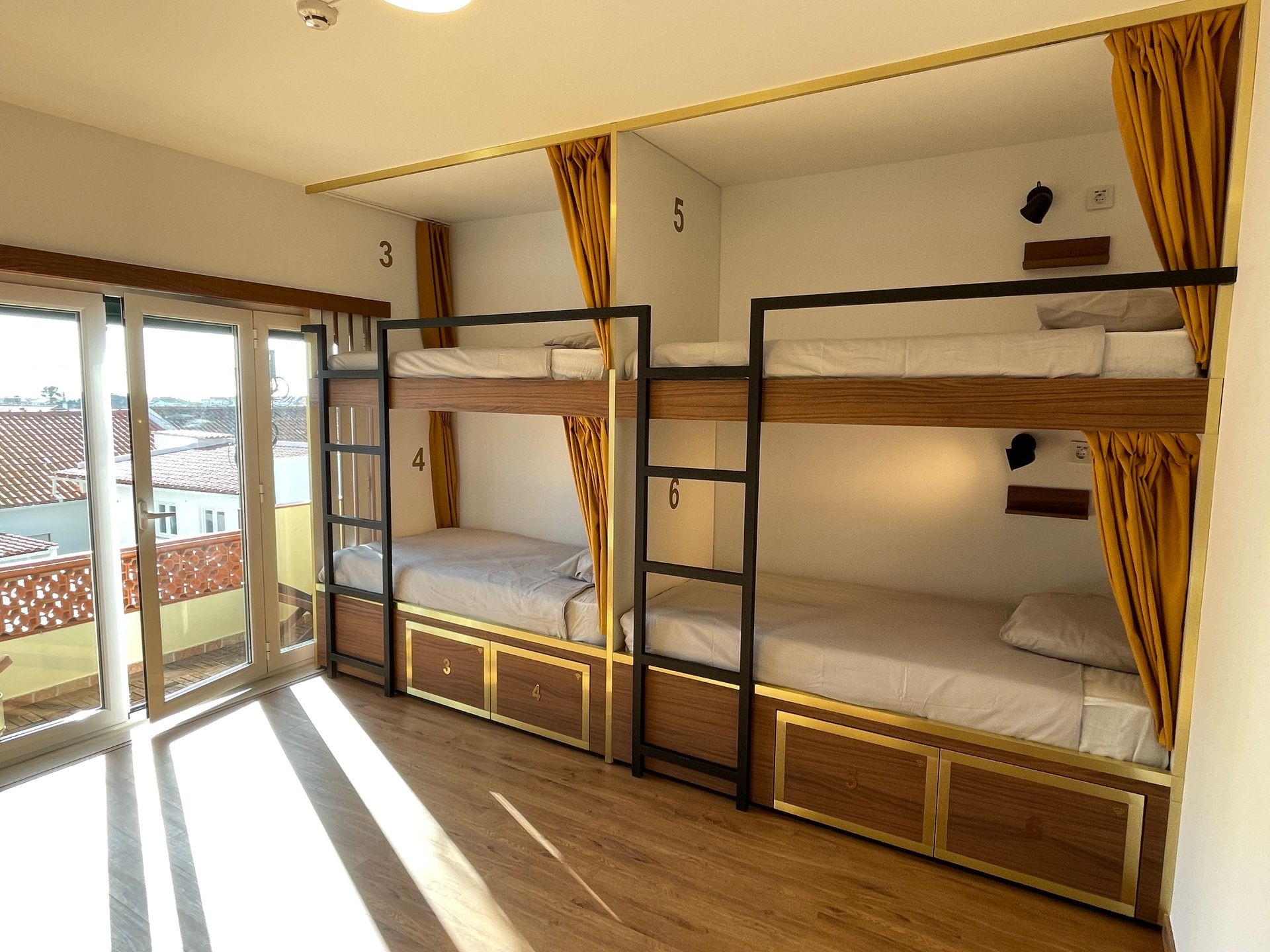 A room with bunk beds and a sliding glass door