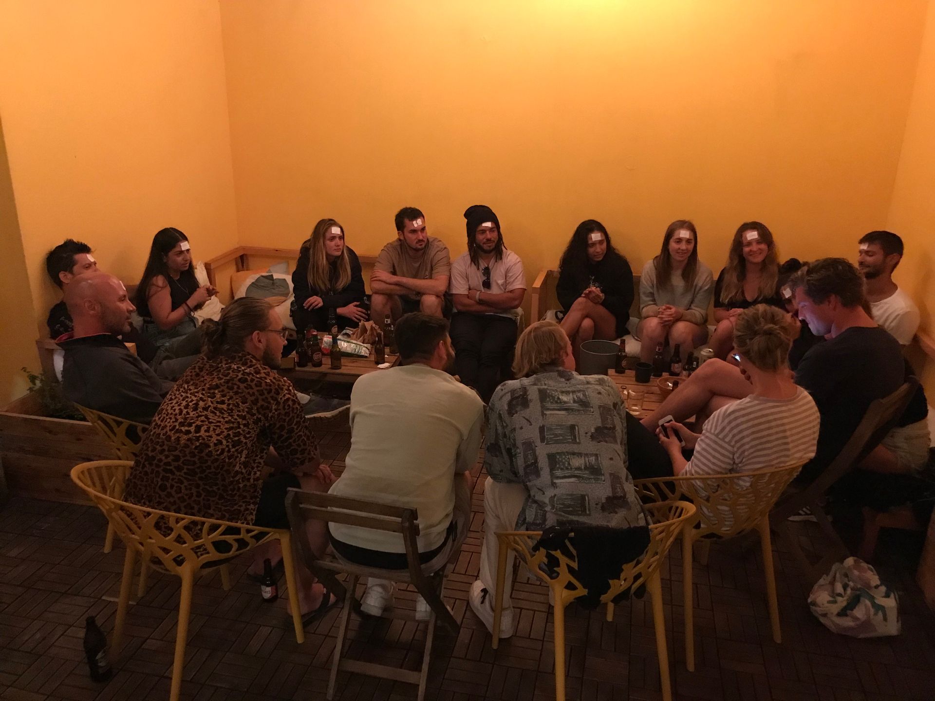 A group of people are sitting in a circle in a room