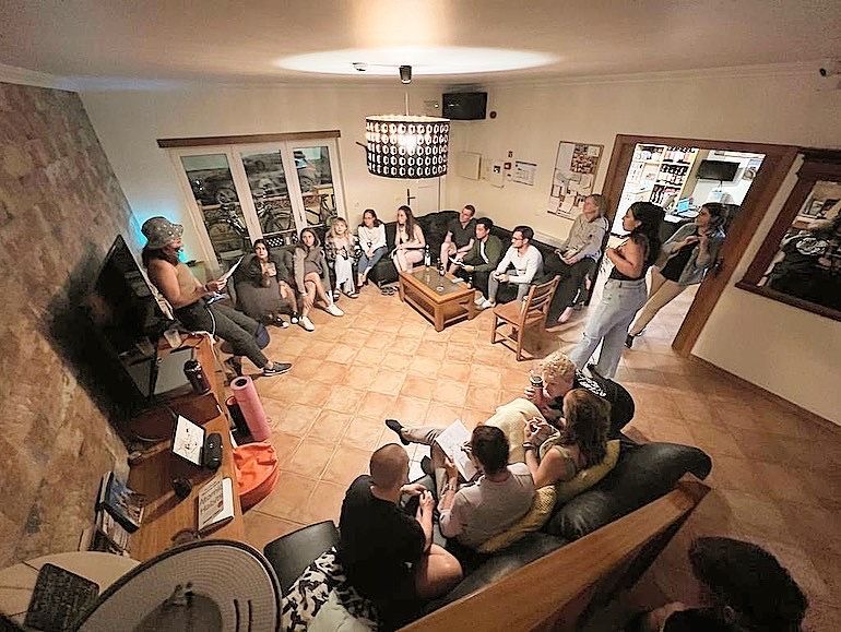A group of people are sitting in a living room.