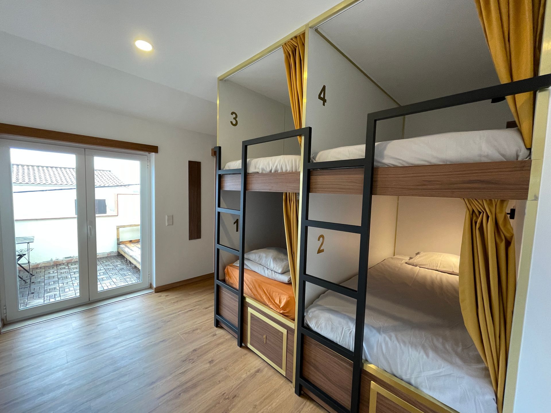 A room with bunk beds and a sliding glass door.