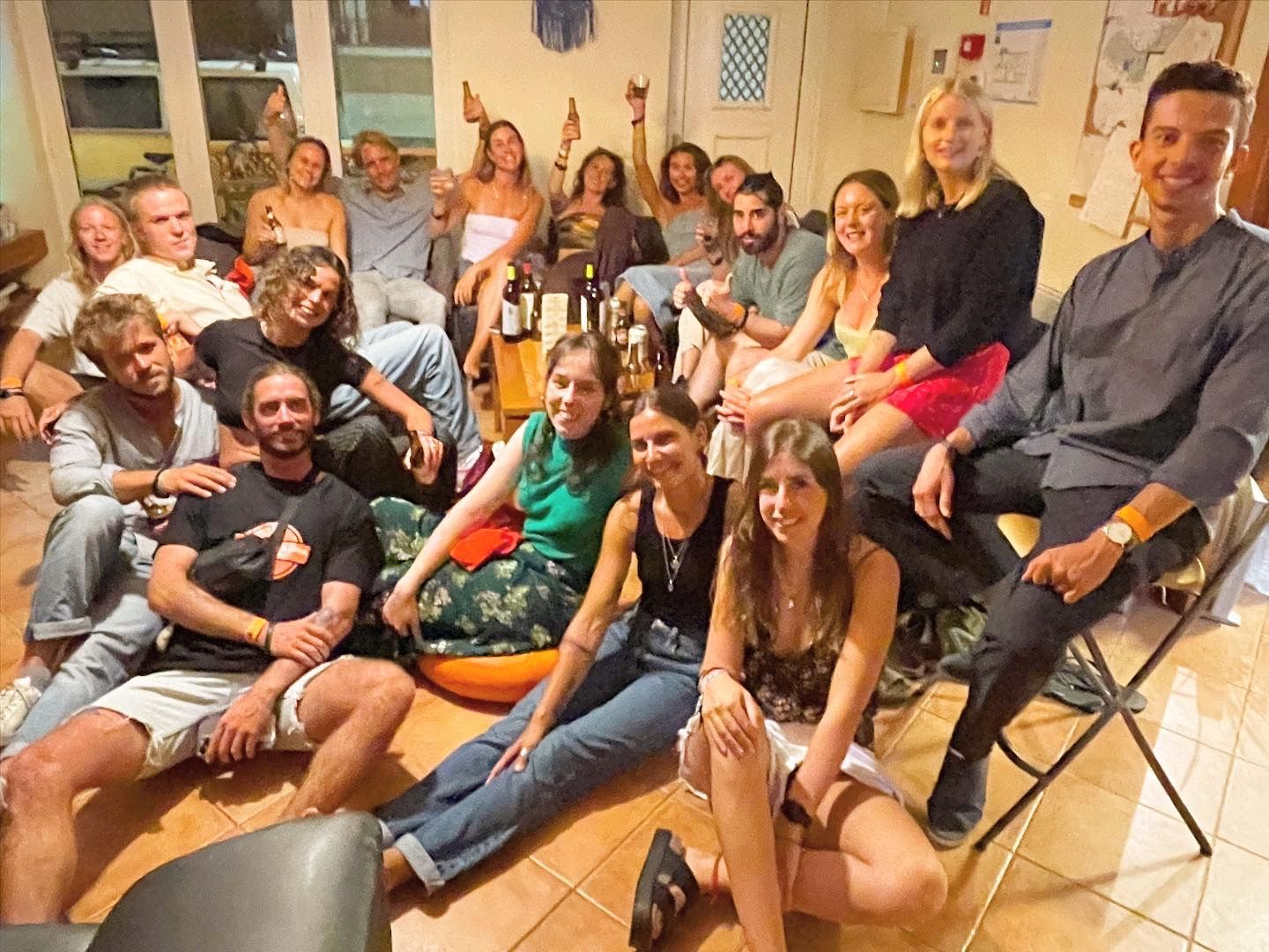 A group of people sitting on the floor posing for a picture