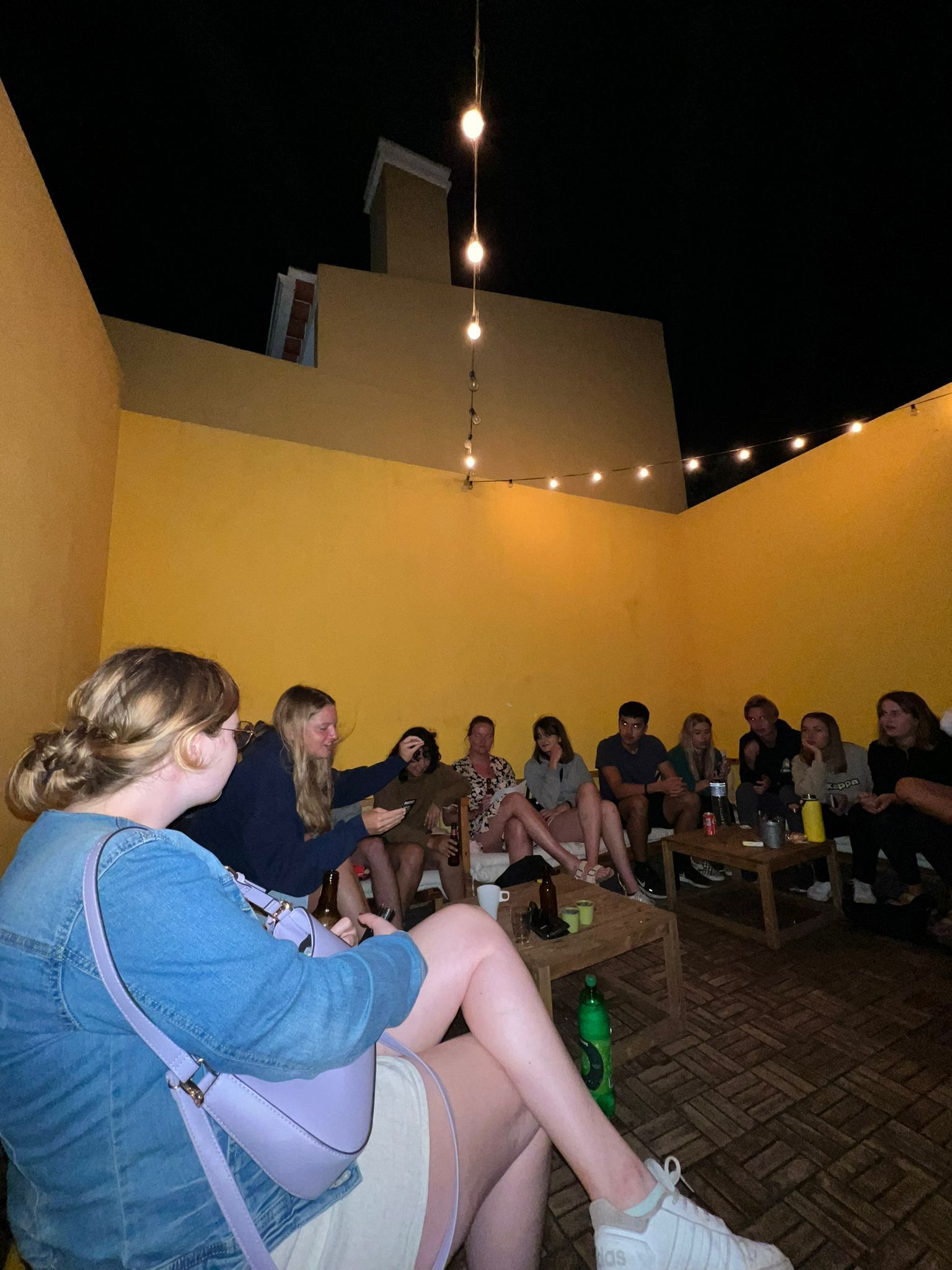 A group of people are sitting around a table in a room.