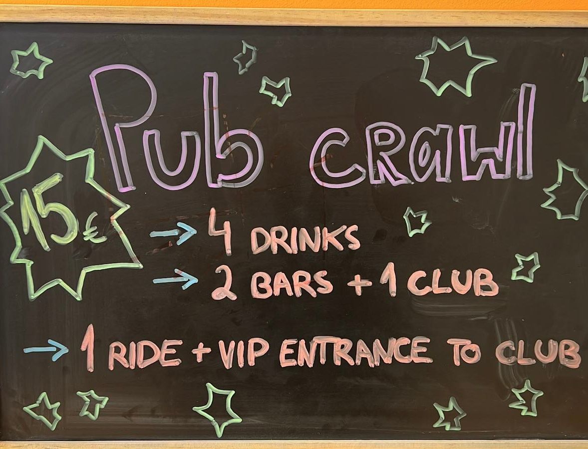 A blackboard advertises a pub crawl for 15 euros